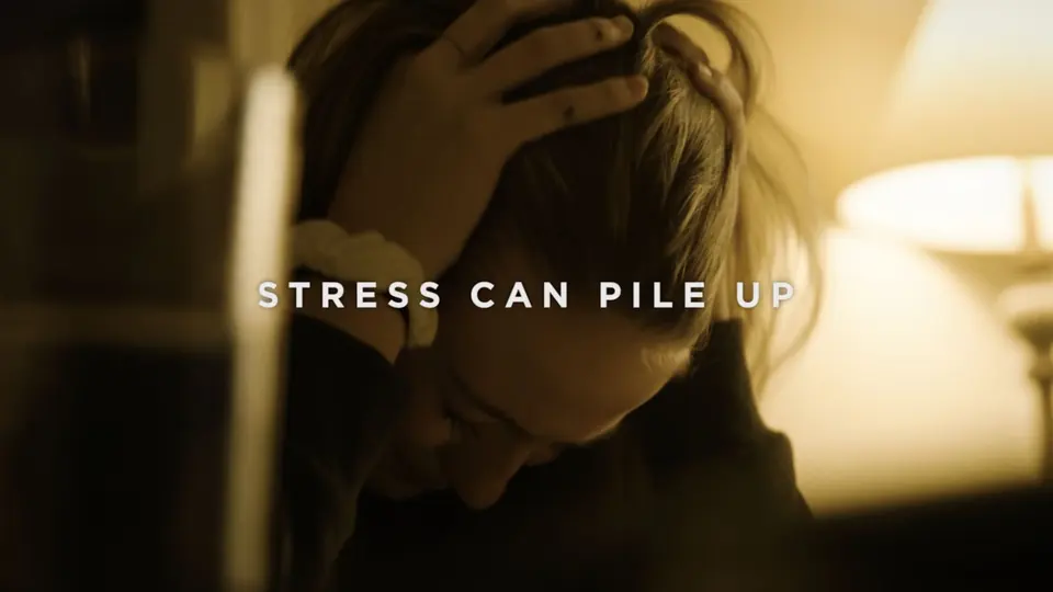 A teen holding her head under the line: Stress can pile up.
