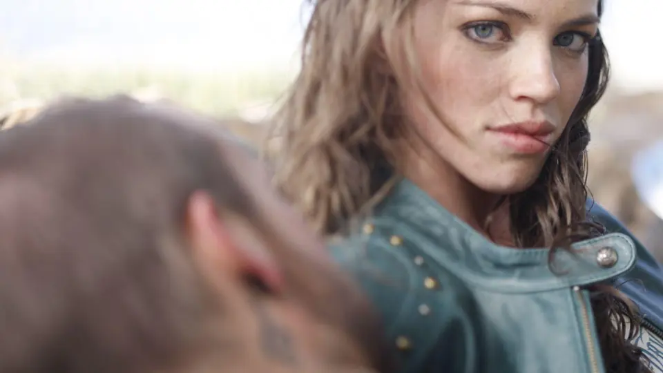 A close-up of a woman in a riding jacket.