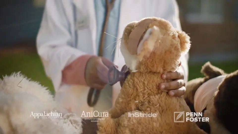 A child examining a teddy bear with a stethoscope.