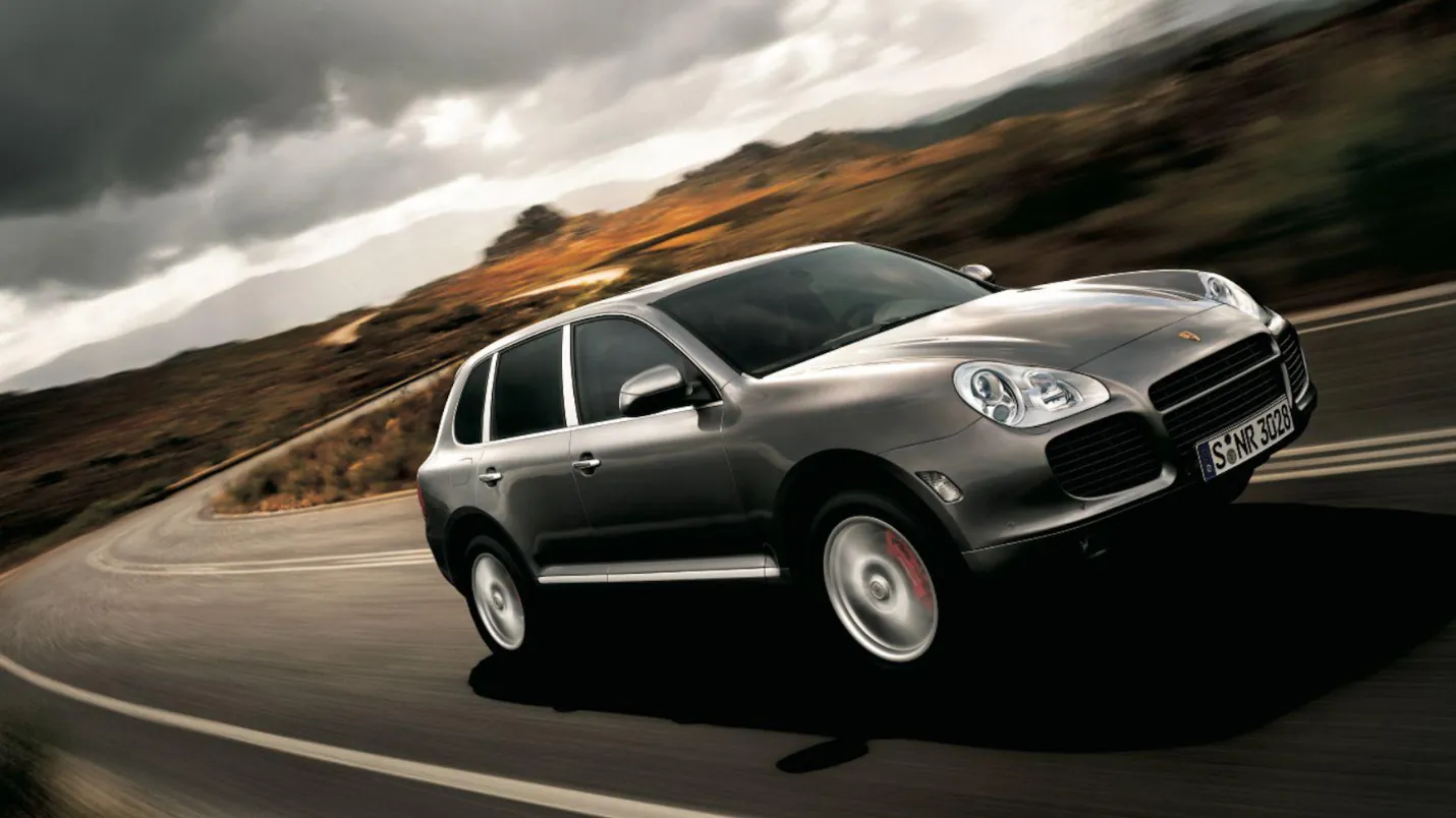 A Cayenne driving a mountain road.