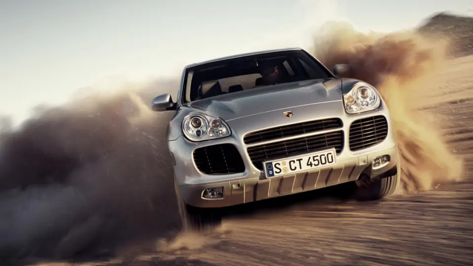 A Cayenne kicking up dust off-road.