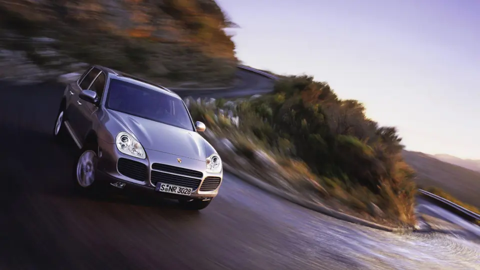 A Cayenne on a coastal road.