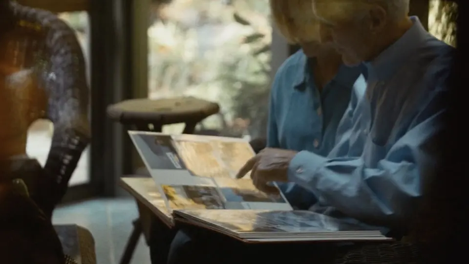 A man looking through a photo album.