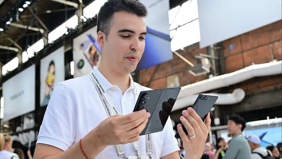 An attendee holding a foldable phone.