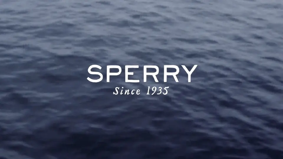 The Sperry logo over dark water.