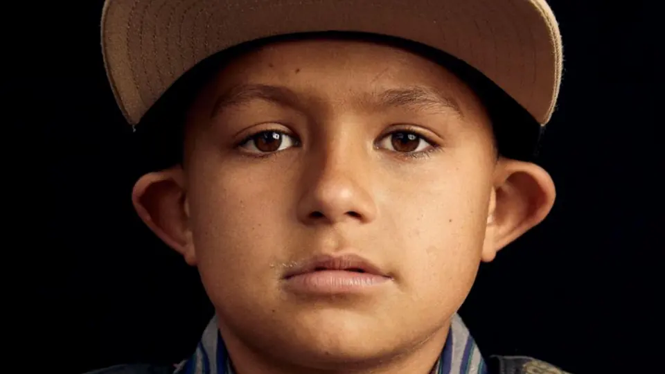 A portrait of a boy in a cowboy hat.