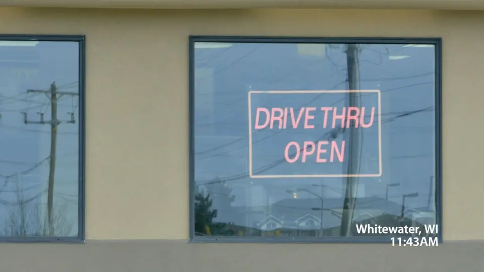 A neon sign reading Drive Thru Open in Whitewater, Wisconsin.
