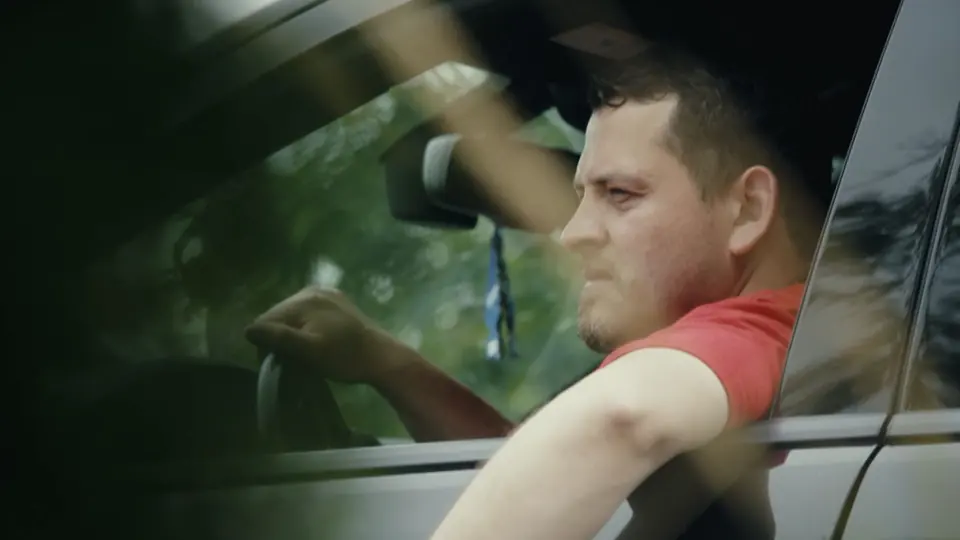 A driver reacting at the window.